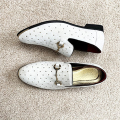 White slip-on loafers featuring gold-tone studs, a metallic horsebit detail, and a gold insole.