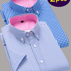 Two men's short-sleeve button-up shirts with blue gingham patterns and pink checkered collars.