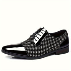 A black and white lace-up Oxford dress shoe with a patterned side panel and a rubber sole.