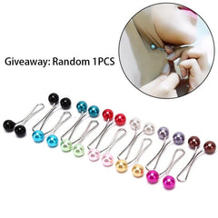 A collection of colorful pearl-tipped hijab pins arranged in a row on a white background.