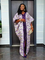 A woman wears a loose-fitting purple and white patterned satin abaya with a sequined center panel.