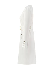 A side view of a white, fitted, long-sleeved V-neck dress featuring decorative gold buttons.