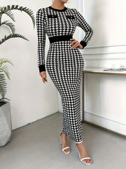 A woman wears a long-sleeved, bodycon houndstooth knit dress with a crew neck and button details.