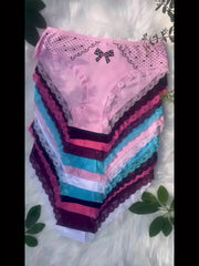A stack of twelve colorful cotton briefs featuring contrast lace trim and a small bow detail.