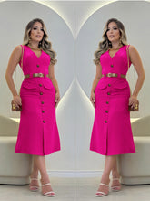 A sleeveless pink midi dress with a V-neck, button front, faux pockets, and a tan belt.