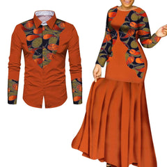 A man's long-sleeved shirt and a woman's long dress in matching orange fabric with patterned accents.