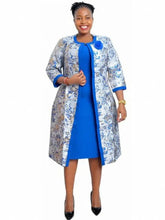 A woman wears a blue sheath dress paired with a floral print open-front coat.
