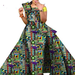 A woman wears a floor-length, off-the-shoulder dress featuring a vibrant, geometric African print.