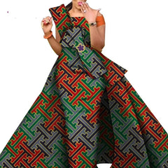 A woman wears a floor-length African print skirt featuring a geometric pattern in red, green, and gold.