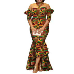 A woman wears a long, off-the-shoulder African print dress with ruffled sleeves and a high-low hem.