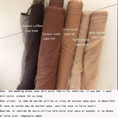 Five rolls of tulle fabric in various skin tone shades ranging from light to dark brown.