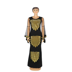 A black floor-length mermaid dress with gold sequin fan patterns and sheer flare sleeves.