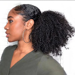 A woman wearing a kinky curly afro drawstring ponytail hair extension in a natural black color.