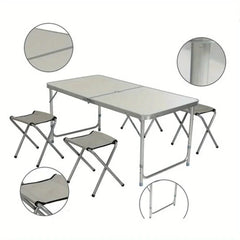 A portable aluminum folding table with a white surface and four matching folding stools.
