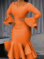 A woman wears an orange bodycon dress with cold shoulders, long flared sleeves, and ruffled hem.