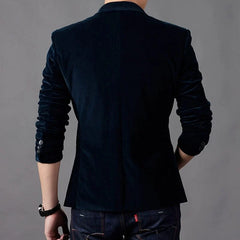 A man wears a dark blue slim-fit corduroy blazer with a single-breasted design from the back.