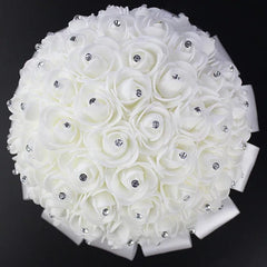 A round white foam rose bridal bouquet accented with sparkling rhinestones and a satin ribbon base.