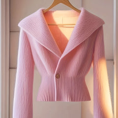 A light pink long-sleeve knit cardigan with a deep V-neck, wide collar, and single button closure.