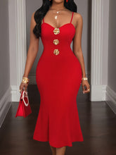A woman wears a red, spaghetti-strap bodycon midi dress featuring three gold rose-shaped buttons.
