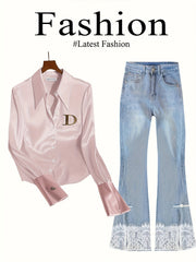 A light pink satin button-down shirt with a gold D logo paired with light-wash flared lace jeans.