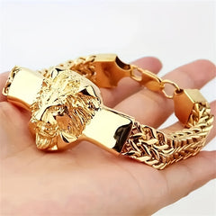 A gold-plated stainless steel bracelet featuring a lion head centerpiece and a braided chain.