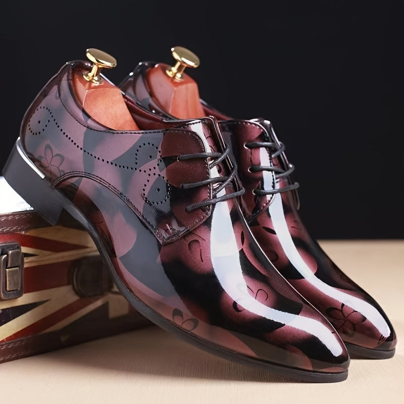 A pair of men's burgundy floral pattern faux leather oxford dress shoes with a pointed toe.