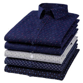 A stack of five folded men's long-sleeve button-down shirts in various patterns and colors.
