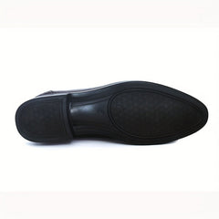 The underside of a black men's dress shoe featuring a textured rubber sole and a low heel.