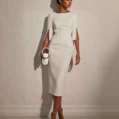 A woman wears a white midi-length bodycon dress with half sleeves and pearl button details.
