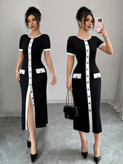 A black and white color block midi dress with a crew neck, short sleeves, and front button detail.