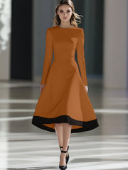 A woman wears a long-sleeved, rust-colored midi dress with a black hem and a cinched waist.