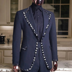 A dark navy two-piece suit featuring a notched lapel and hemline embellished with black crystals.