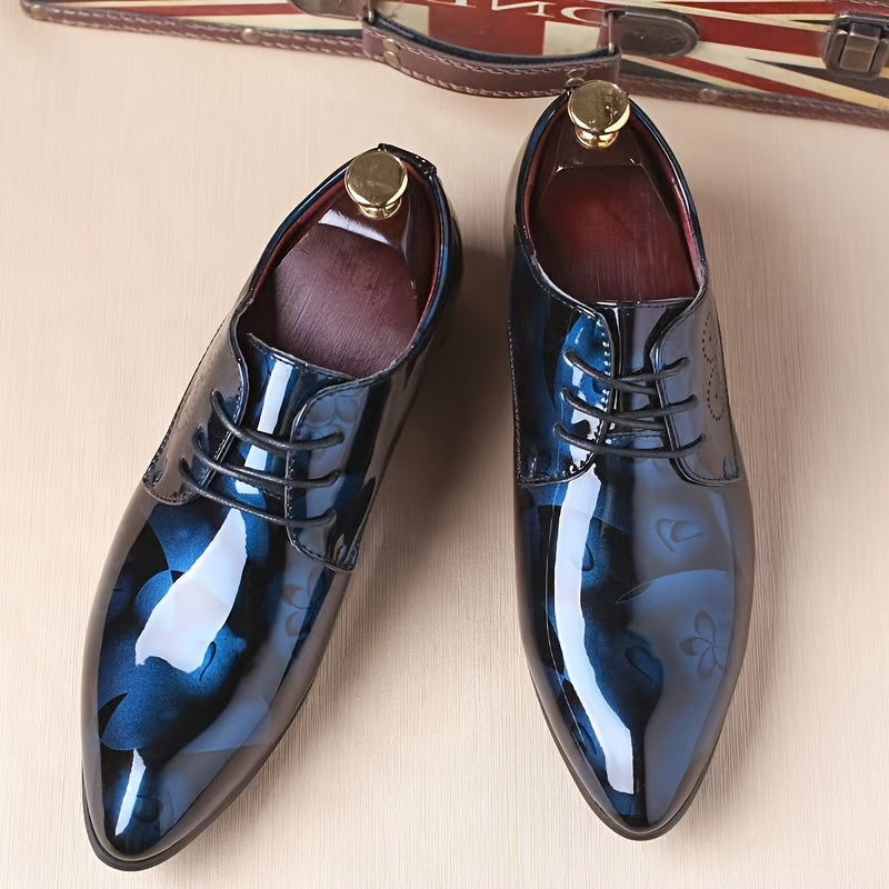 A pair of men's pointed-toe oxford dress shoes featuring a glossy blue floral pattern.