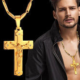 A gold-colored stainless steel crucifix pendant necklace worn by a man.