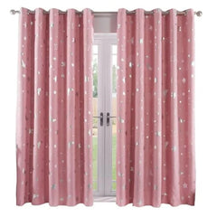 A pair of pink blackout curtains featuring a silver star and moon print with grommet tops.