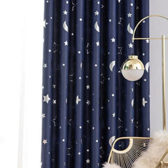 Navy blue blackout curtains featuring a printed pattern of silver stars and crescent moons.