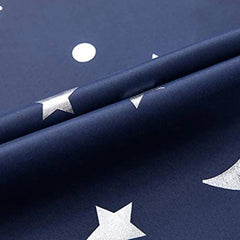 Navy blue blackout curtain fabric featuring a printed pattern of silver stars and moons.
