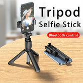 A black Bluetooth selfie stick tripod shown in both its extended standing position and folded.