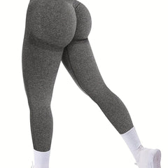 A person wears high-waisted, seamless, grey butt-lifting leggings with white socks.