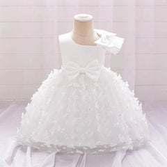 A white sleeveless baby dress featuring a large bow at the waist and butterfly-adorned tulle skirt.