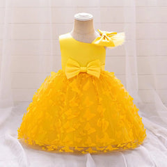 A yellow knee-length baby girl dress featuring a bow at the waist and butterfly tulle skirt.