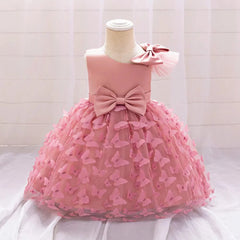 A pink knee-length baby girl party dress featuring a large bow and butterfly tulle overlay.