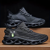 A pair of black breathable mesh sneakers with lace-up closures and textured blade-style soles.