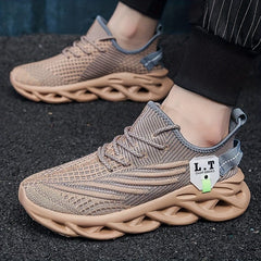 A pair of tan breathable mesh sneakers with a unique blade-style sole and lace-up closure.