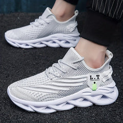 Lightweight grey mesh sneakers with a white blade-style sole and lace-up closure.