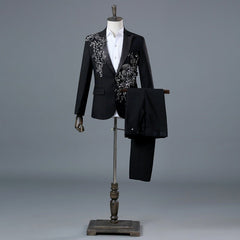 A black single-breasted suit featuring intricate sequin and diamond floral embroidery.