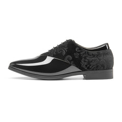 A black lace-up dress shoe featuring a glossy patent leather toe and a velvet floral-patterned side.