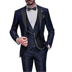 A man wears a slim-fit navy blue three-piece suit with a polka dot bow tie and pocket square.