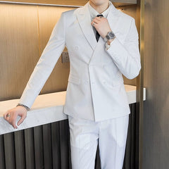A man wears a white double-breasted business suit with a white shirt and black tie.