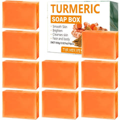 Nine bars of orange turmeric soap are arranged around their product packaging box.